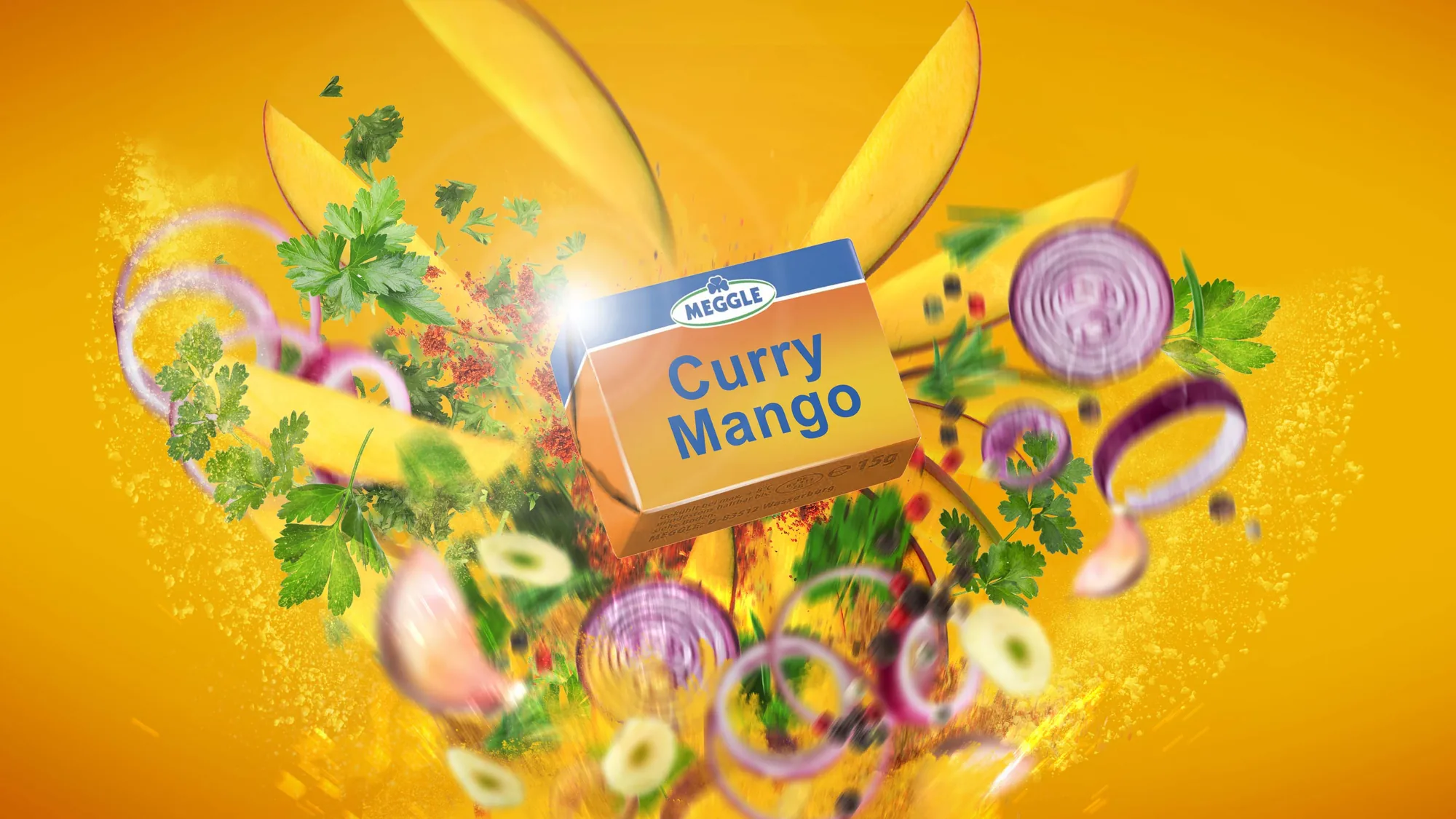 Product key visual for a Meggle butter variety — the pack bursting from an explosion of mango, herbs and onion