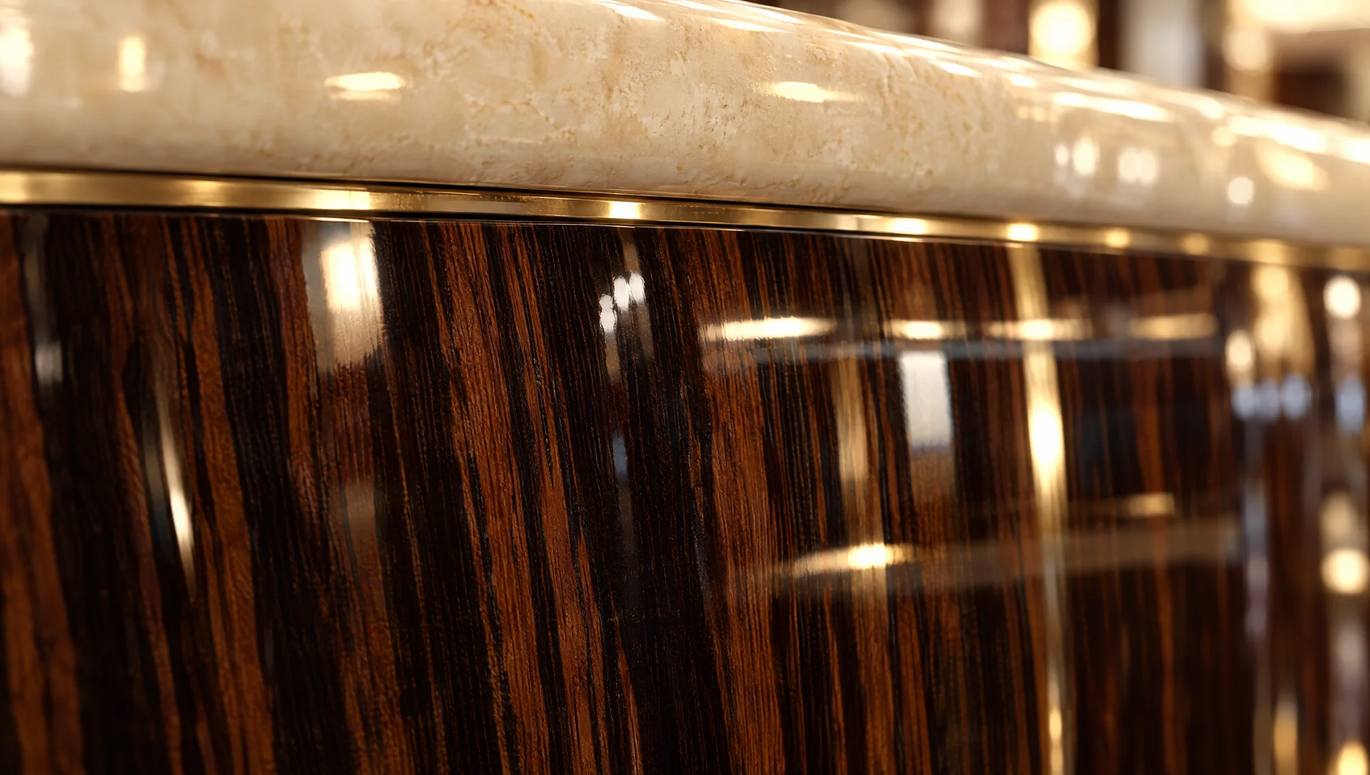 Detail of the bar — marble counter, brass trim and high-gloss macassar ebony