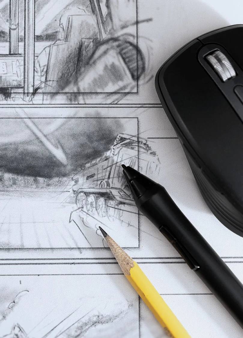 Storyboard pencil sketches on the desk with pencil, pen and mouse