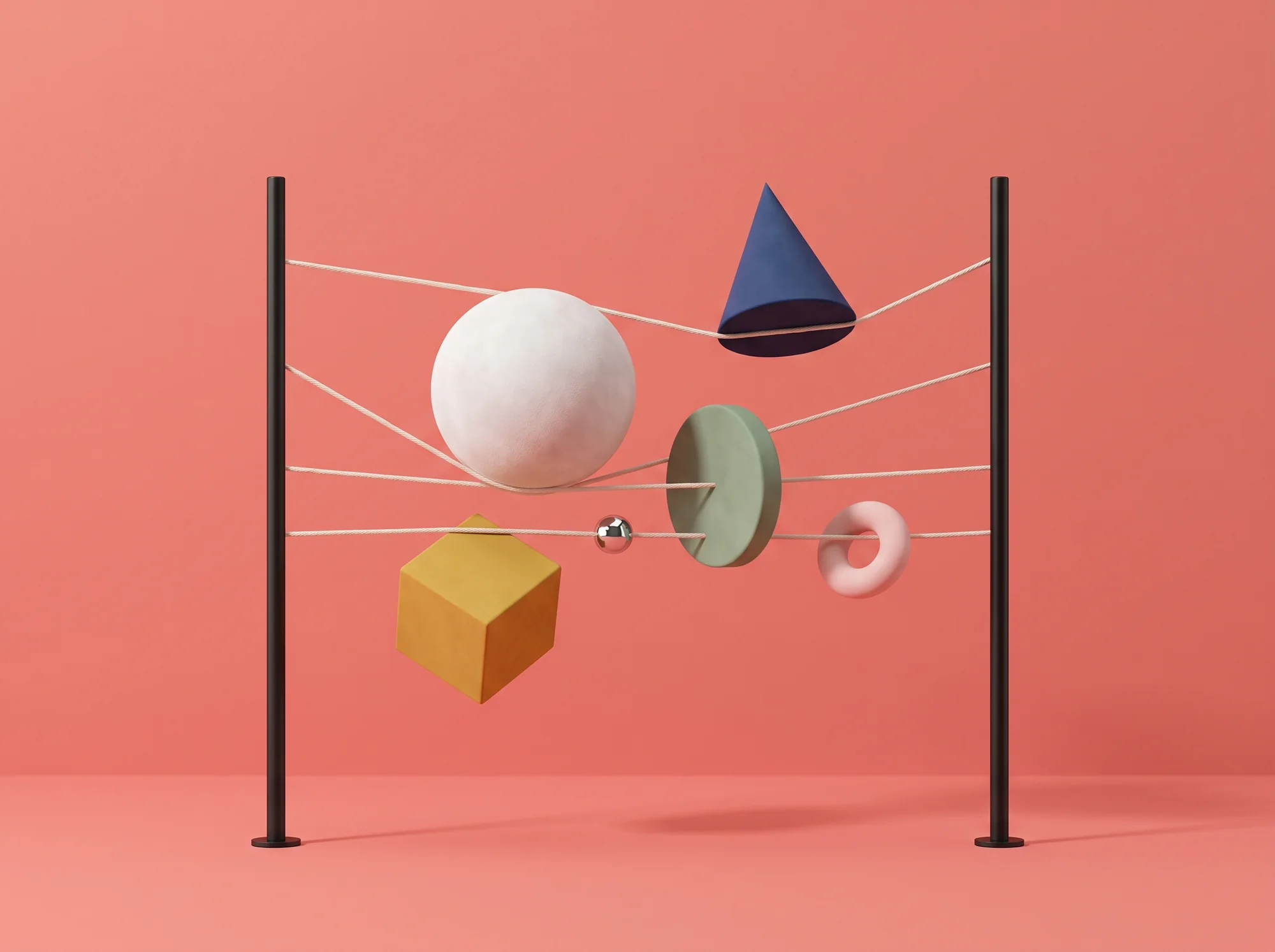 Shapes caught in strings between two black poles on coral — white sphere, blue cone, yellow cube, sage disc, pink torus